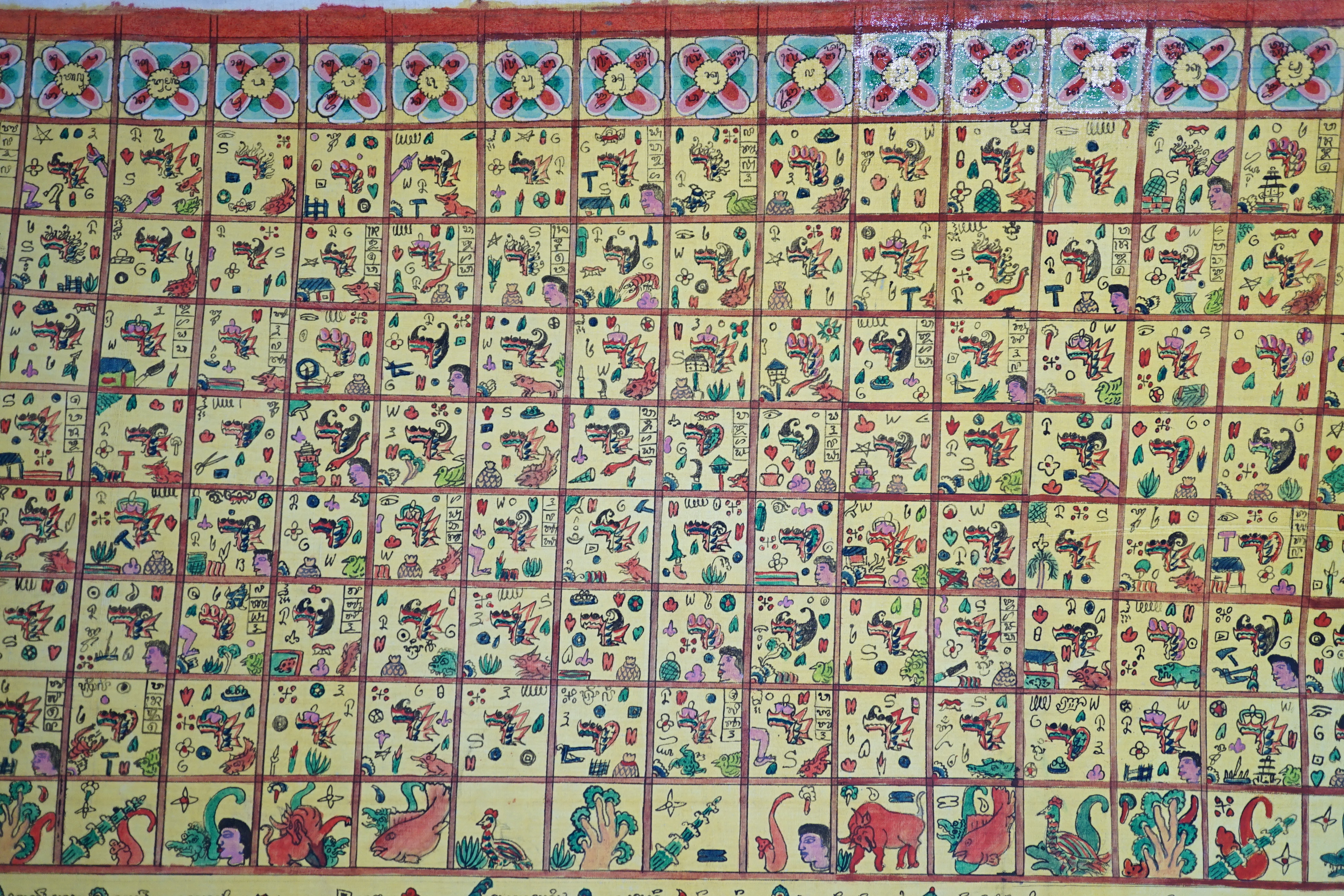 An Indonesian hand painted calendar and two similar figures, tallest 21cm